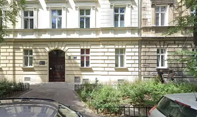 a building with a door and a car parked in front at Bogusławskiego 5 by Homeprime in Kraków