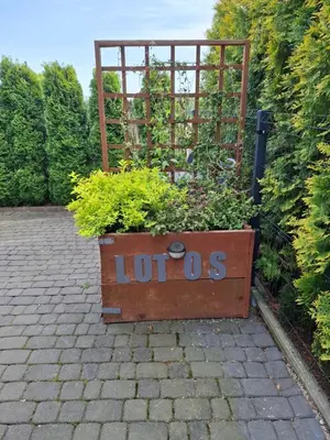 a wooden crate filled with plants in a garden at Apartament Lotos in Zator