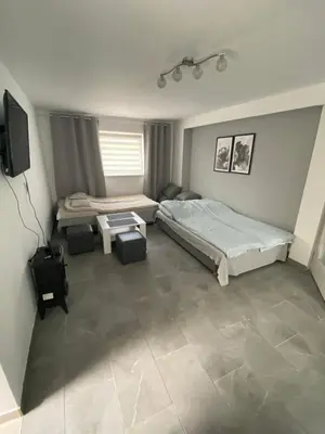 a bedroom with two beds and a flat screen tv at Apartament Lotos in Zator