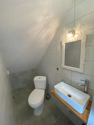 a bathroom with a toilet and a sink at Apartament Lotos in Zator