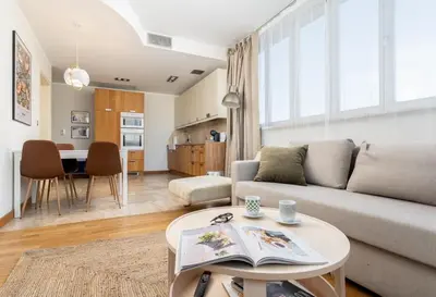 a living room with a couch and a table at Łobzowska 22 by Homeprime in Kraków