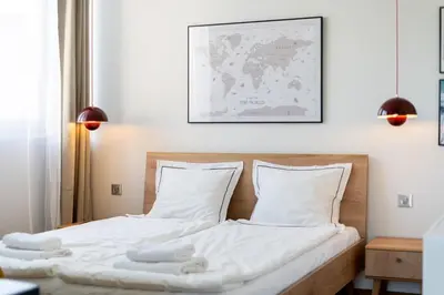 a bedroom with two beds with white sheets at Łobzowska 22 by Homeprime in Kraków