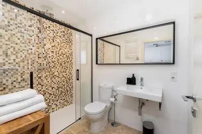 a bathroom with a toilet and a sink and a mirror at Łobzowska 22 by Homeprime in Kraków