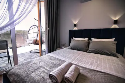 a bedroom with a large bed with towels on it at Apartament dla dwojga in Zator