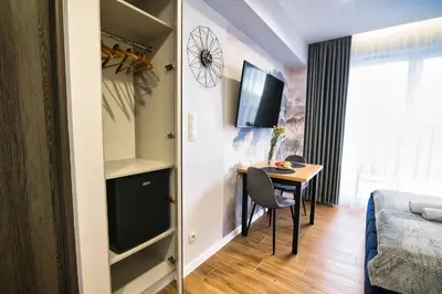 a small room with a table and a bed at Apartament dla dwojga in Zator