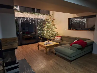 a living room with a couch and a christmas tree at Reset Kudłacze in Pcim