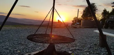 a swing with the sunset in the background at Reset Kudłacze in Pcim