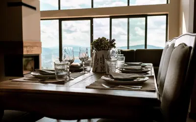 a dining room table with plates and glasses on it at Reset Kudłacze in Pcim