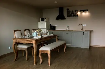 a kitchen with a table and chairs and a kitchen with a sink at Reset Kudłacze in Pcim