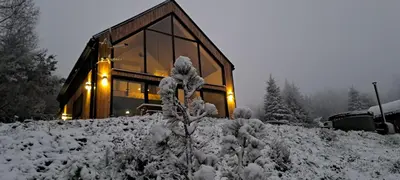 a house on top of a snow covered hill at Reset Kudłacze in Pcim