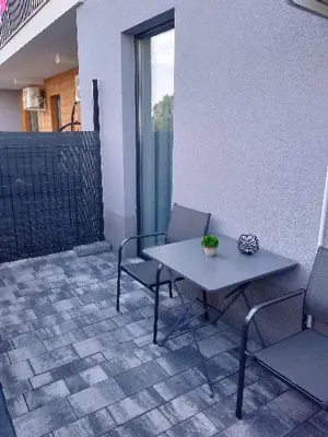 a table and two chairs on a patio at Capital apartaments in Zator