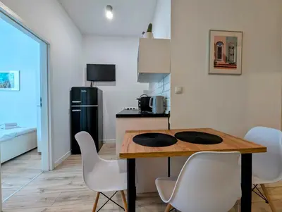a kitchen and dining room with a table and chairs at Mazowiecka 11 by Homeprime in Kraków