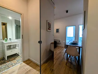 a bathroom with a sink and a table and a mirror at Mazowiecka 11 by Homeprime in Kraków