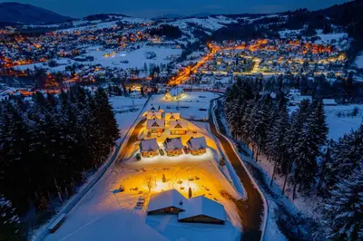 an aerial view of a resort in the snow at night at Kompleks Gazdówka - Domki Rabka-Zdrój in Ponice