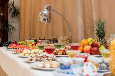 a table with many plates of food on it at Hotel Artur in Kraków
