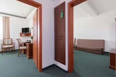 an open door to a room with a couch at Hotel Artur in Kraków