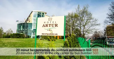 a hotel sign in front of a building at Hotel Artur in Kraków