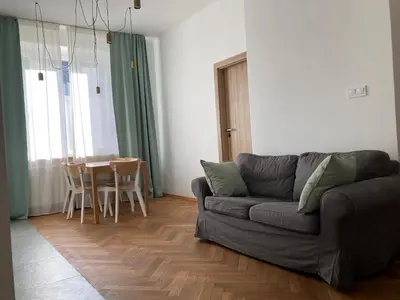 a living room with a couch and a table at Apartament z klimatyzacją in Kraków