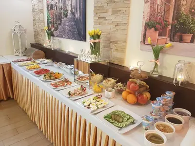 a long table with many plates of food on it at Hotel Relax in Kęty