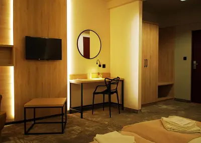 a hotel room with a desk and a mirror at Hotel Relax in Kęty