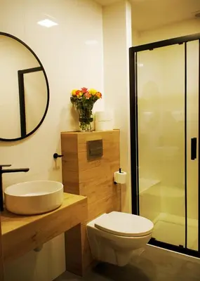 a bathroom with a sink and a toilet and a mirror at Hotel Relax in Kęty