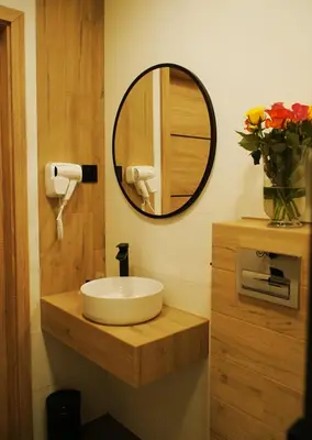a bathroom with a sink and a mirror at Hotel Relax in Kęty