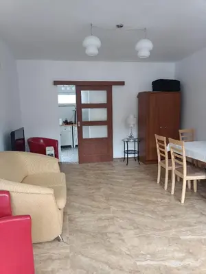 a living room with a couch and a table and chairs at Viking Rożnów in Rożnów