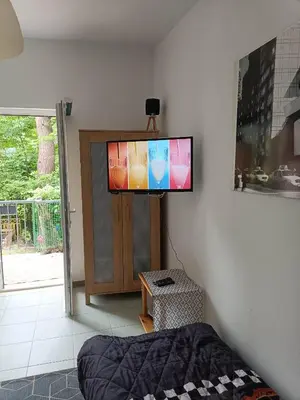 a flat screen tv on a wall in a bedroom at Viking Rożnów in Rożnów