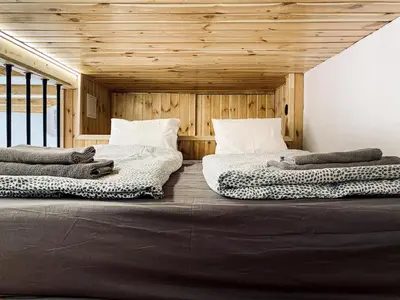 two beds sitting next to each other in a room at Charming Studio with Air Conditioning, Old Town & Kazimierz in Kraków