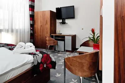 a hotel room with a bed and a desk at Jasmin Complex Resort & Spa in Krzeszów Dolny