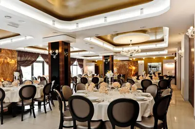 a conference room with tables and chairs and a chandelier at Jasmin Complex Resort & Spa in Krzeszów Dolny