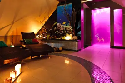 a living room with a fish tank and a couch at Jasmin Complex Resort & Spa in Krzeszów Dolny