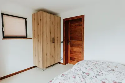 a bedroom with a bed and a wooden door at Skava Apartments Zator Energylandia in Wadowice