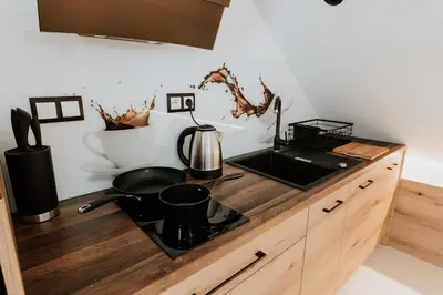 a kitchen with a counter top with a pot on a stove at Skava Apartments Zator Energylandia in Wadowice