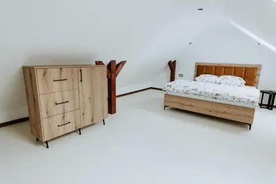 a bedroom with a bed and a dresser at Skava Apartments Zator Energylandia in Wadowice