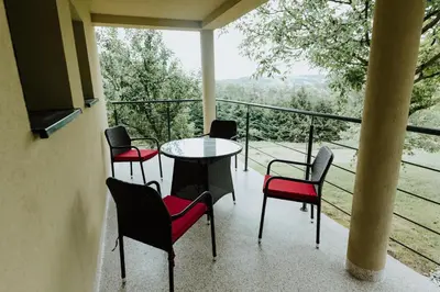 a balcony with a table and chairs and a view at Skava Apartments Zator Energylandia in Wadowice