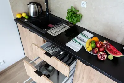 a kitchen counter with a bowl of fruit on it at Aparts Near Main Station in Kraków