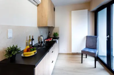 a kitchen with a plate of fruit on a counter at Aparts Near Main Station in Kraków