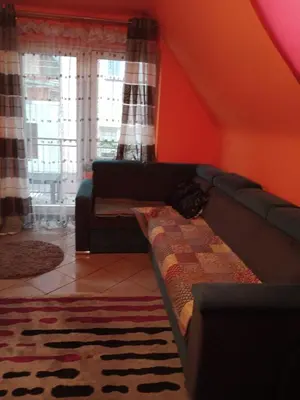 a living room with a couch and a window at Uroczy apartament in Kraków