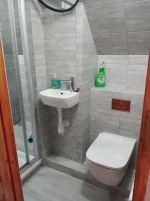 a bathroom with a toilet and a sink and a shower at Uroczy apartament in Kraków