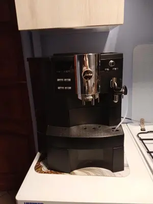 a black coffee maker sitting on top of a counter at Uroczy apartament in Kraków