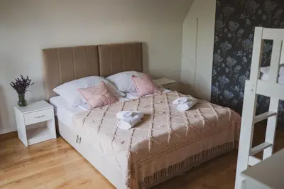 a bedroom with a bed with two towels on it at Dom Marika - Energylandia Zator in Zator