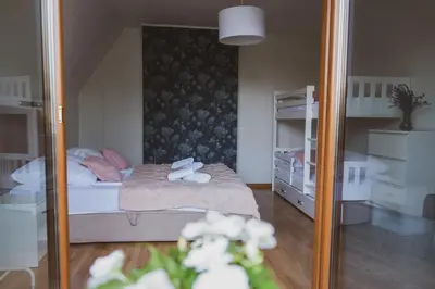 a reflection of a bedroom with a bed and a mirror at Dom Marika - Energylandia Zator in Zator