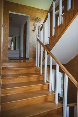 a staircase in a home with wood floors at Dom Marika - Energylandia Zator in Zator