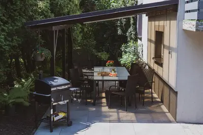 a patio with a table and chairs and a grill at Dom Marika - Energylandia Zator in Zator