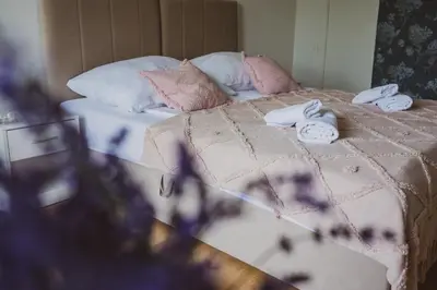 a bedroom with a bed with towels on it at Dom Marika - Energylandia Zator in Zator
