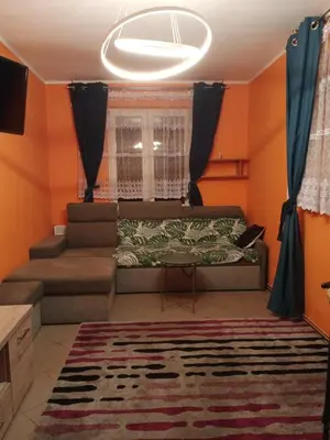 a living room with a couch and a table at Uroczy Apartament in Kraków