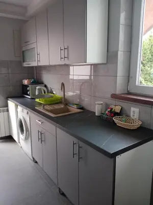 a kitchen with a sink and a counter top at Uroczy Apartament in Kraków