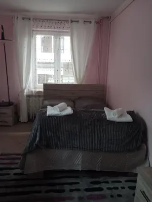 a bedroom with a bed with two towels on it at Uroczy Apartament in Kraków