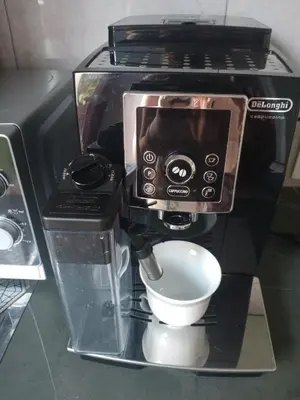 a coffee machine with a cup inside of it at Uroczy Apartament in Kraków
